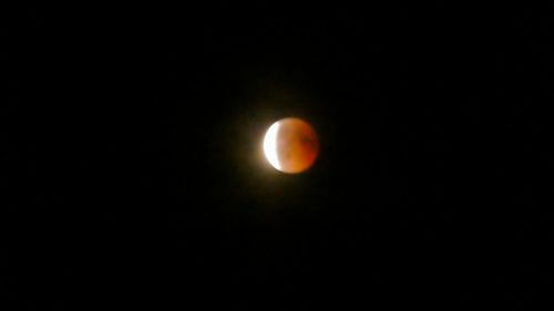 Low angle view of moon against sky at night