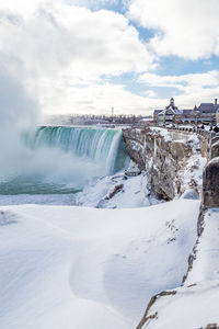 Scenic view of niagara falls against sky during winter
