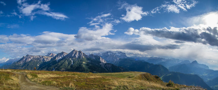 Scenic view of mountains against cloudy sky