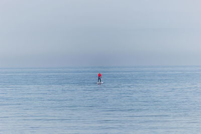 Person on sea against sky