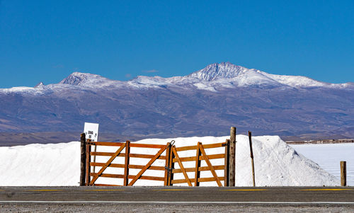 Scenic view of snowcapped mountains against clear blue sky