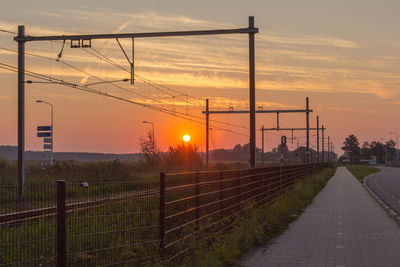 Scenic view of a train track against sky during sunset