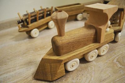 Close-up of wooden toy train on hardwood floor