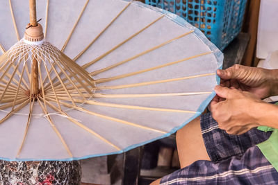 Midsection of woman holding umbrella