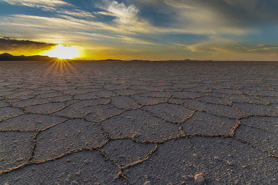 Scenic view of land against sky during sunset