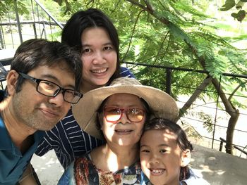 Portrait of happy smiling boy against trees