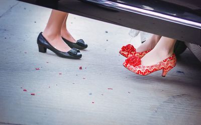 Low section of woman relaxing on tiled floor