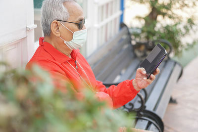 Midsection of person holding mobile phone