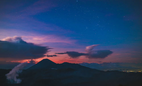 Scenic view of silhouette mountains against sky at sunset