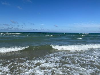 Scenic view of sea against blue sky