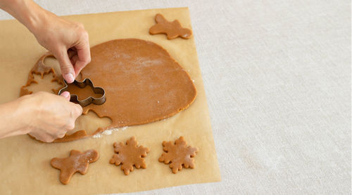 Cropped hand of person preparing food on table