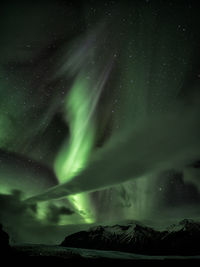 Low angle majestic view of star field and aurora borealis against sky at night