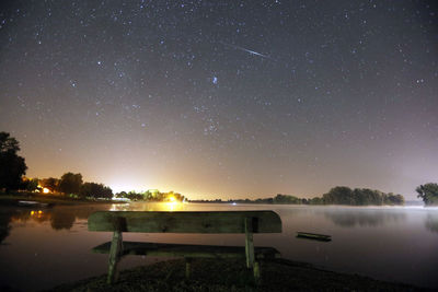 Scenic view of lake against sky at night