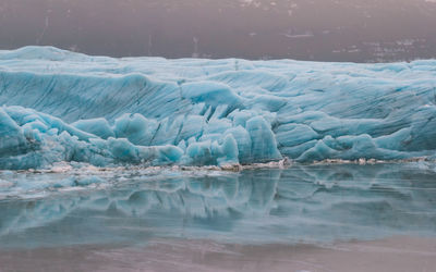 Large glacier reflected in lake landscape photo