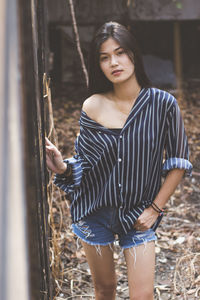 Portrait of young woman standing outdoors