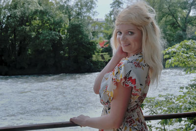 Portrait of smiling woman against plants