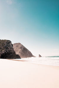 Scenic view of beach against clear sky