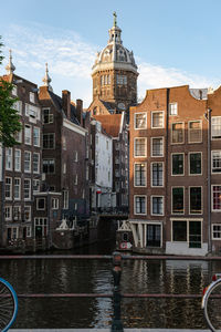 Historical buildings of amsterdam in the sunset light.