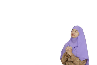 Portrait of a serious young woman over white background