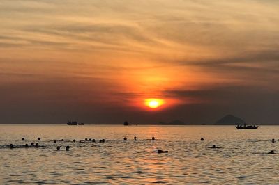 Scenic view of sea against orange sky