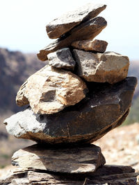 Close-up of stack of rock against sky