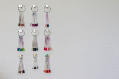 Close-up of key chains hanging on wall