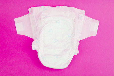 High angle view of paper against pink background