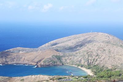 Scenic view of sea and mountains against sky