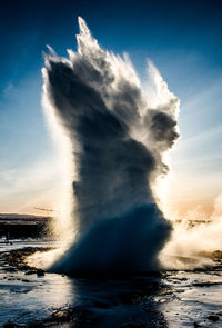 Waves splashing on sea against sky