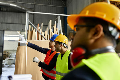 Workers talking in factory workshop