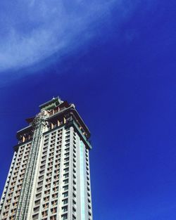 Low angle view of modern buildings against blue sky