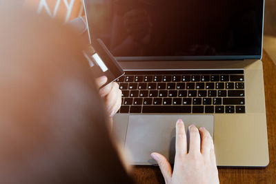 Woman hands holding credit card and using laptop. online shoppin