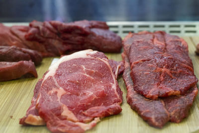 Pieces of fresh raw cut meat in a butcher window display