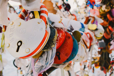 Close-up of decorations hanging in market for sale