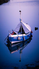 Boat moored on sea against sky