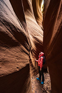 A female explorer is climbing the canyon.