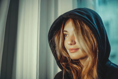 Portrait of a beautiful young woman with a hood