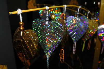 Close-up of illuminated lanterns hanging at night