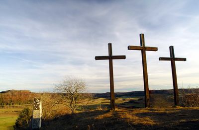 Low angle view of cross against sky