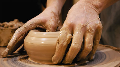 Close-up of person making pottery