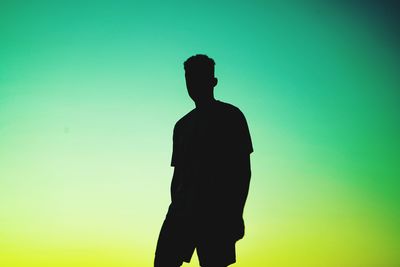 Silhouette man standing against clear sky