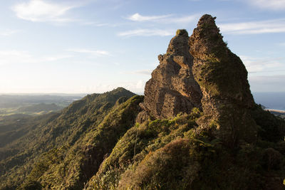 Rock formations on landscape against sky