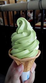 Close-up of hand holding ice cream cone