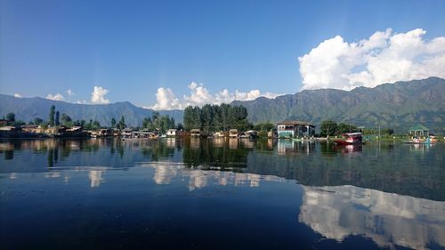 Panoramic view of lake by buildings against sky