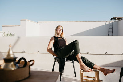 Portrait of a smiling young woman sitting on chair