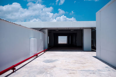 Corridor of building against blue sky