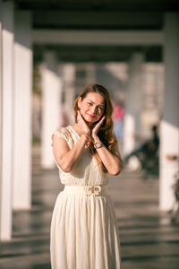 Portrait of a beautiful young woman standing outdoors