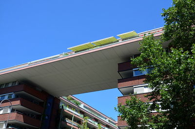 Low angle view of buildings against clear blue sky