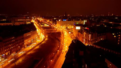 High angle view of city lit up at night