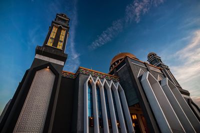 Low angle view of temple and building against sky